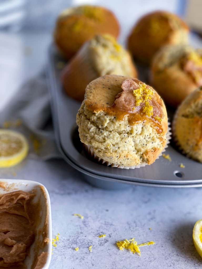 close up of lemon poppy seed muffins with cinnamon honey butter