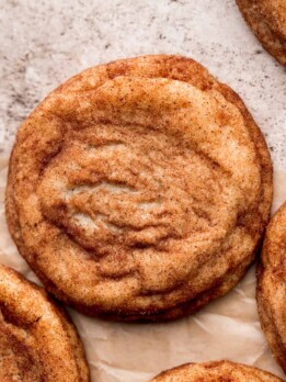 Brown butter snickerdoodle cookies on parchment paper.