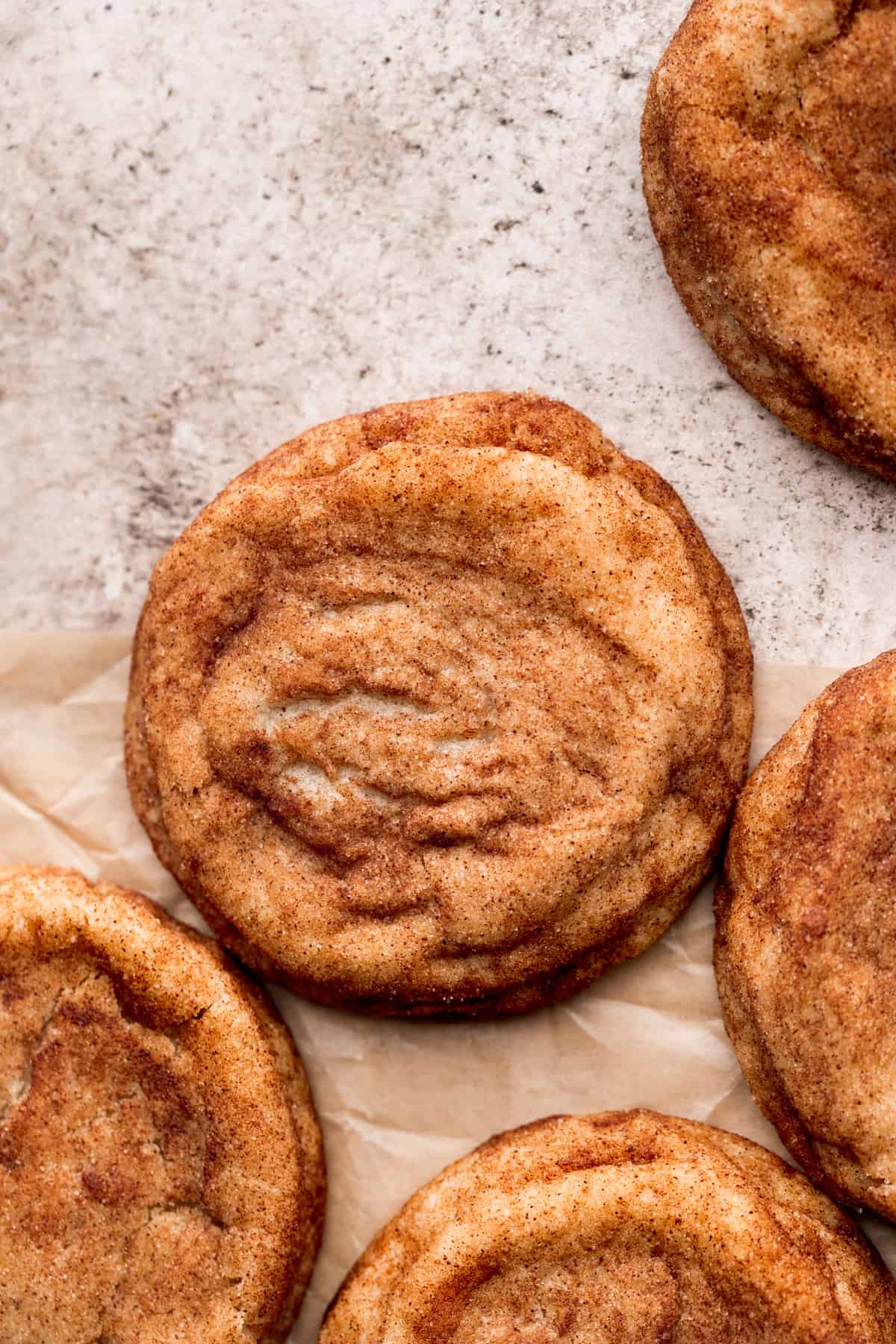 Brown butter snickerdoodle cookies on parchment paper.