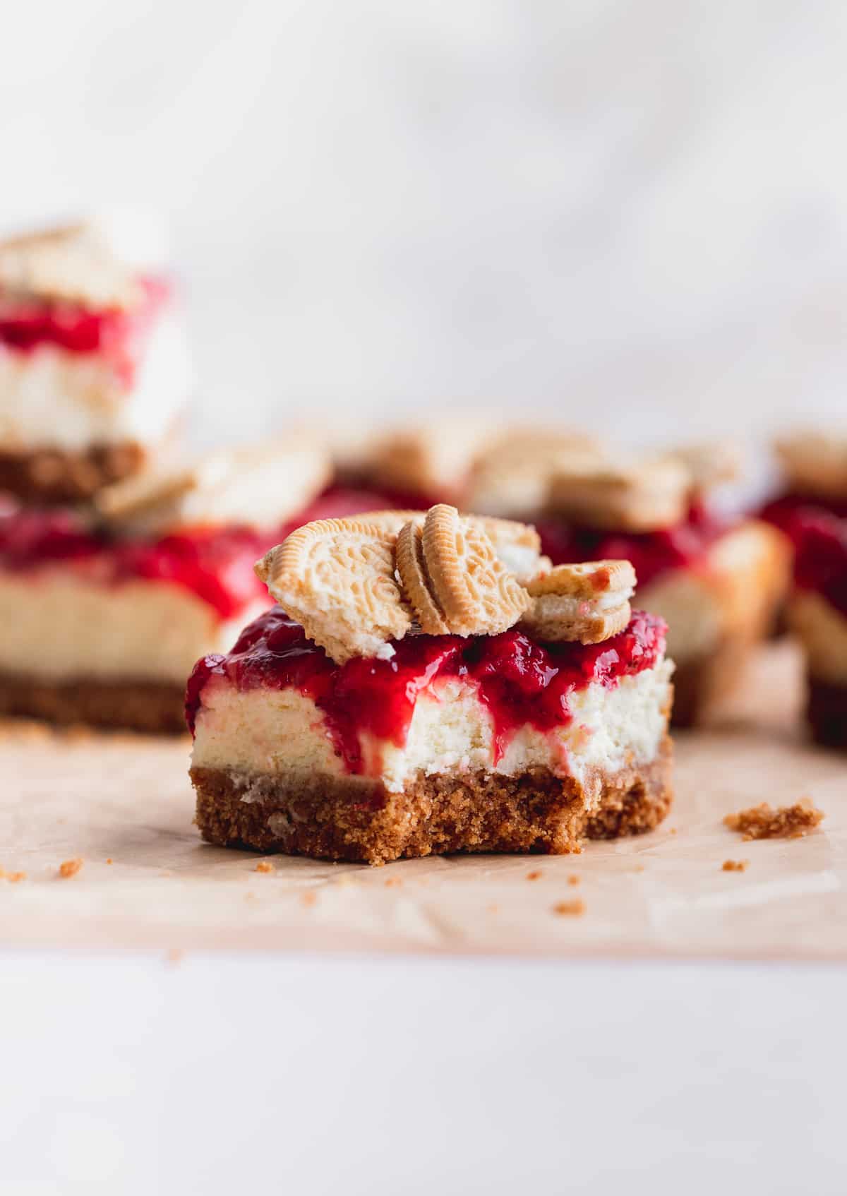 A bite missing from strawberry cheesecake bars.