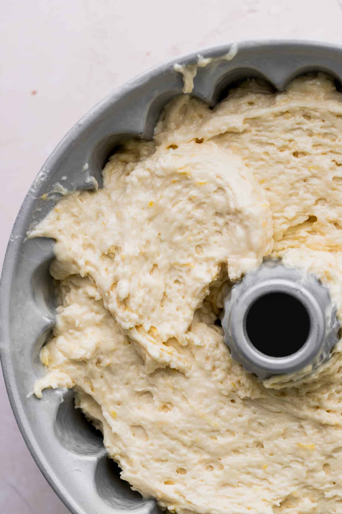 Lemon cake batter in a bundt pan.