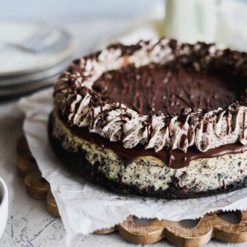 Oreo cheesecake baked on an oreo crust that is creamy and topped with oreo whipped cream.