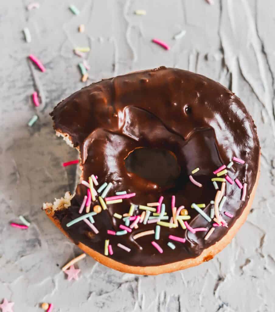 1 easy yeast chocolate glazed doughnuts with a bite taken out