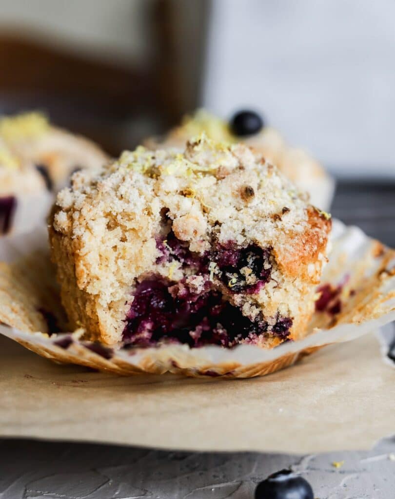 A bite of a lemon blueberry muffins taken out.