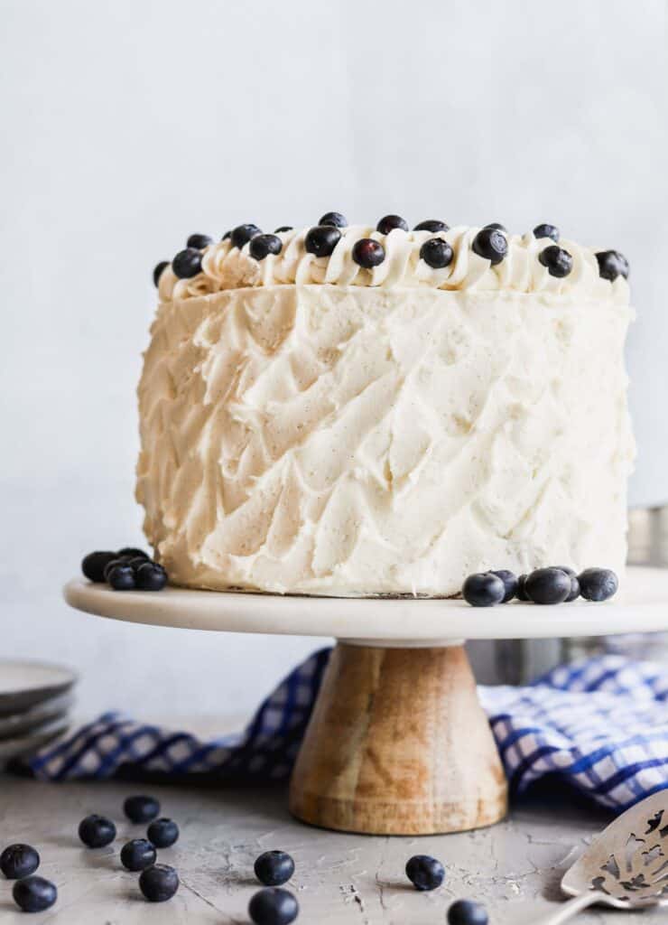 Blueberry jam and cream cake on a cake stand.