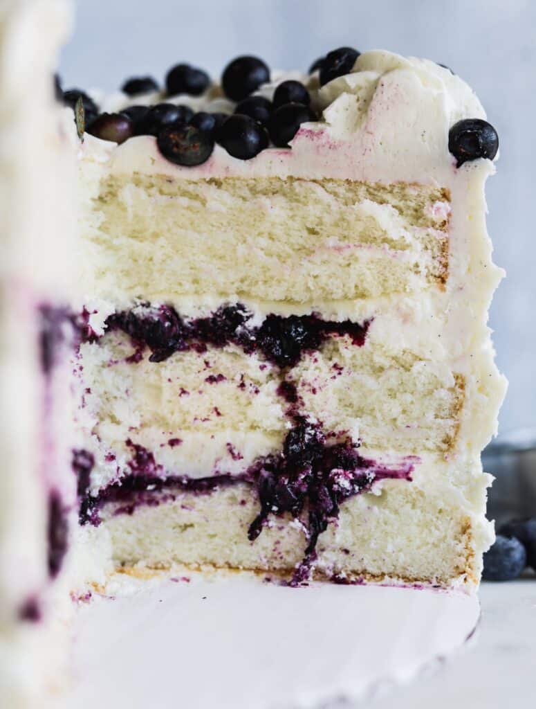 Blueberry jam and cream cake showing off all the layers with the homemade blueberry jam filling.