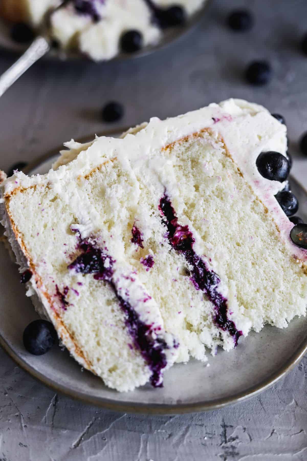 1 slice of blueberry jam and cream cake showing off the whipped cream cheese.