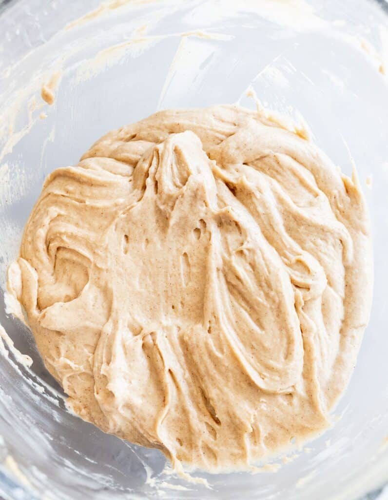 Batter of cinnamon muffin in a glass bowl.