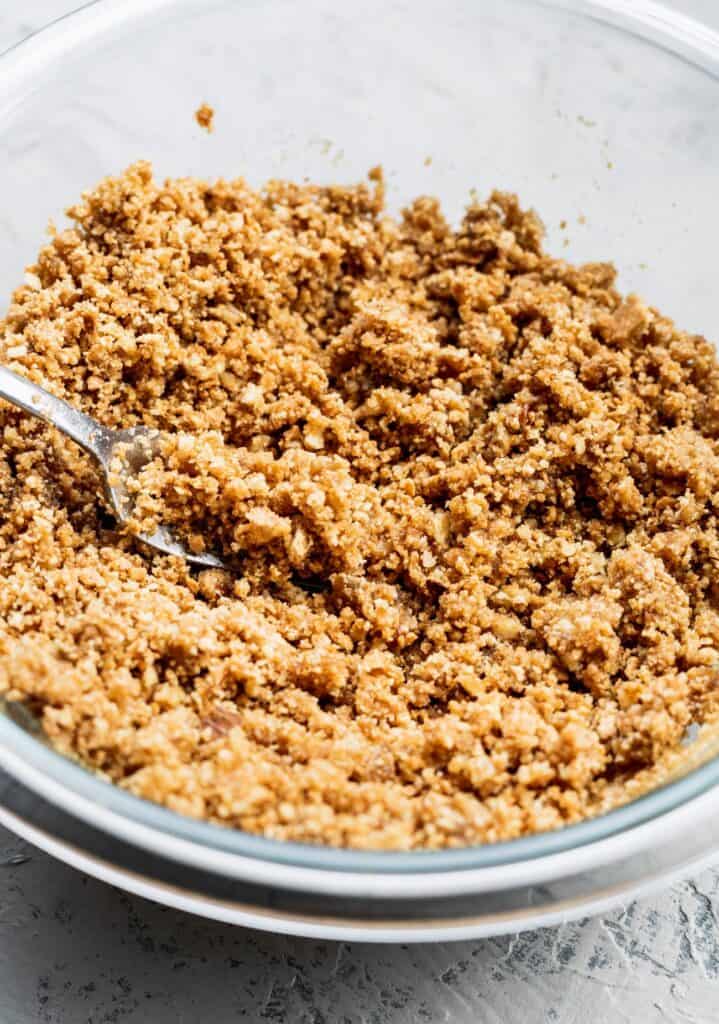 pecan graham cracker crumbs in a glass bowl.