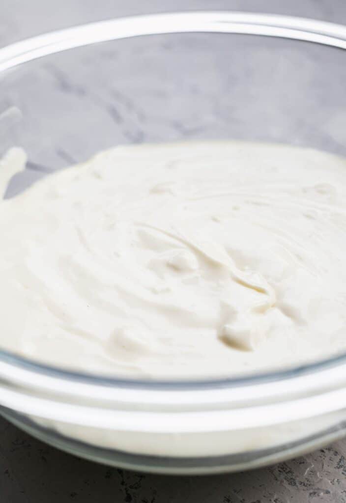 Regular cheesecake batter in a glass bowl.