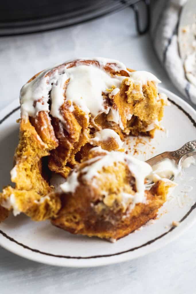 A single pumpkin spice cinnamon roll showing all the layers