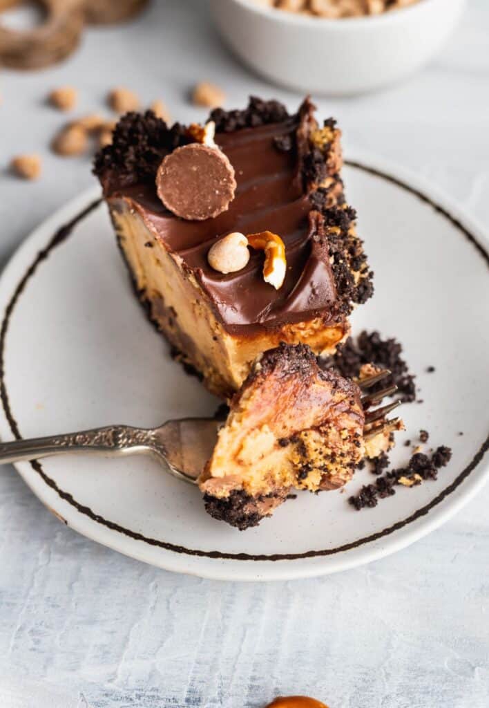 Close up of chocolate peanut butter cup pie with a bite missing.