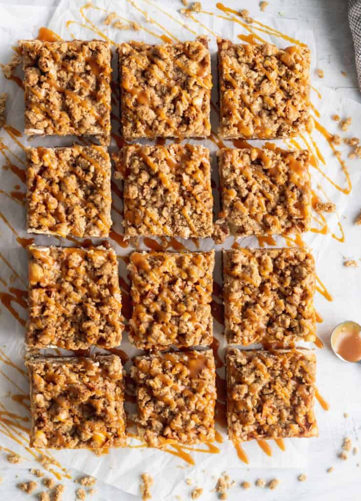 Caramel apple cheesecake bars cut into squares.