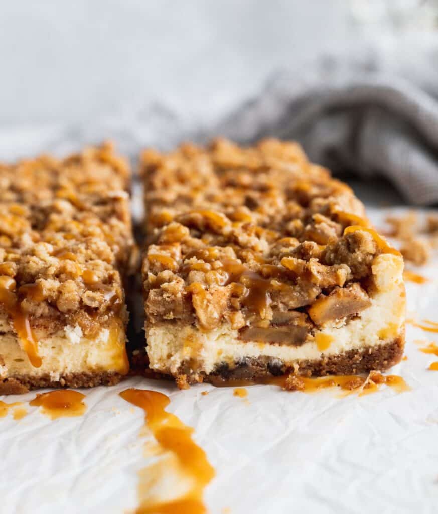 Side shot of caramel apple cheesecake bars to see the layers