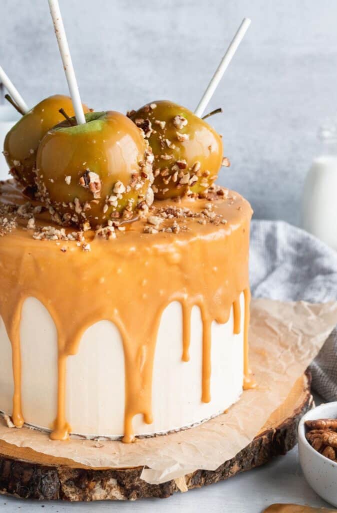 Close up of the caramel apple spice cake with 3 caramel apples on top.