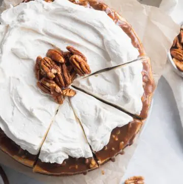 Cinnamon pecan pie cheesecake top view cut into 3 pieces.
