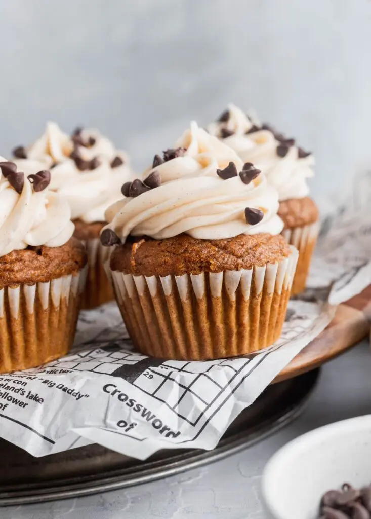 Chocolate stuffed pumpkin cupcakes topped with cinnamon cream cheese frosting.