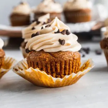 Chocolate stuffed pumpkin cupcakes with 1 unwrapped.