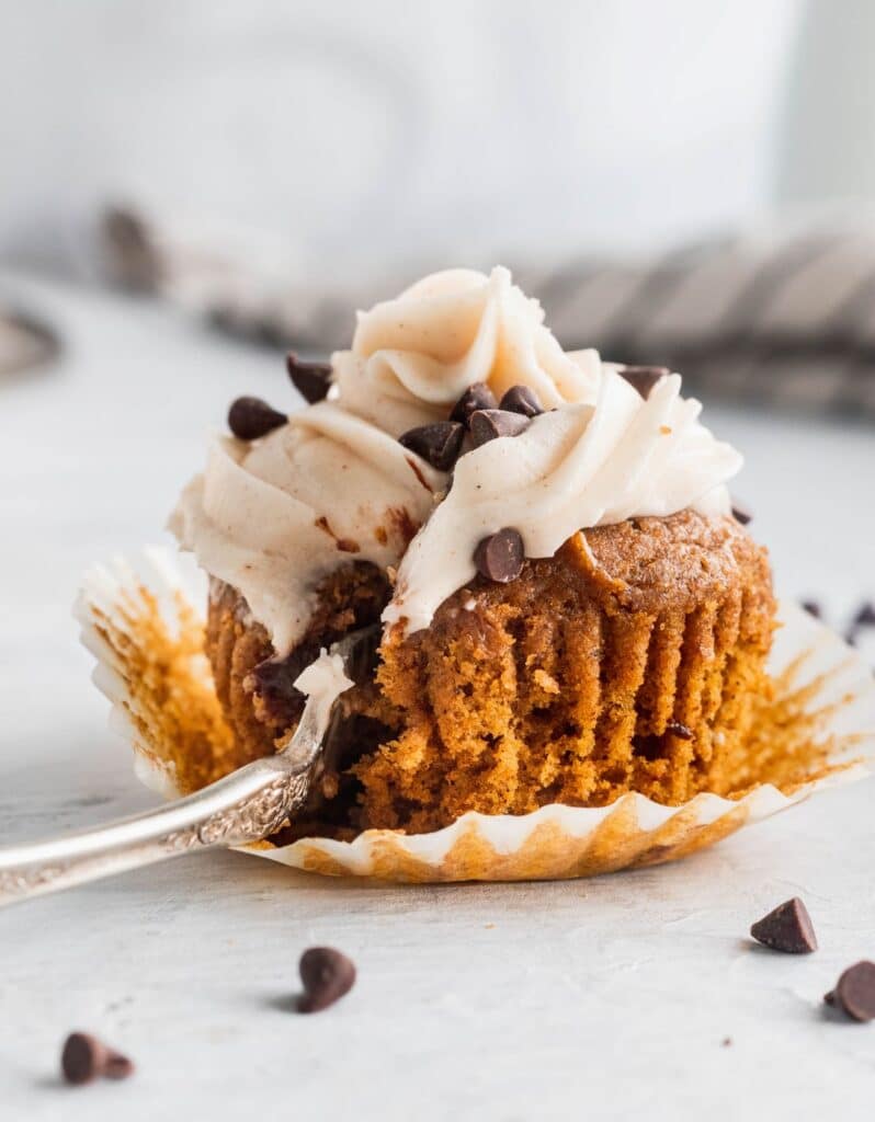 1 chocolate stuffed pumpkin cupcakes with a fork inserted.