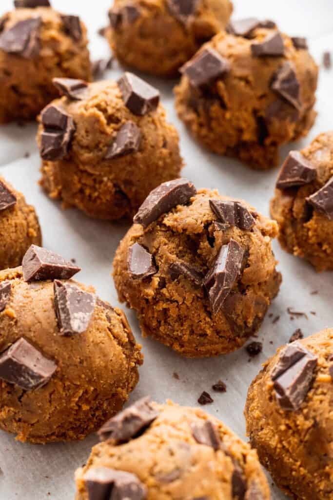 Gingerbread cookie dough balls with chocolate on top.