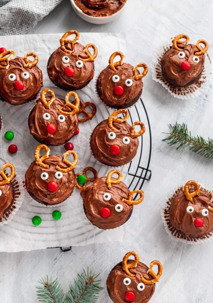 Christmas reindeer cupcakes on a circle cooking rack with m&ms.