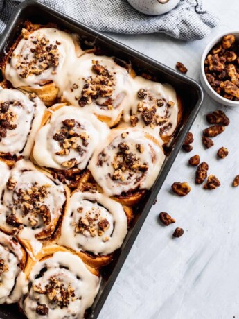 Walnut cinnamon rolls with sweet maple nuts on top.