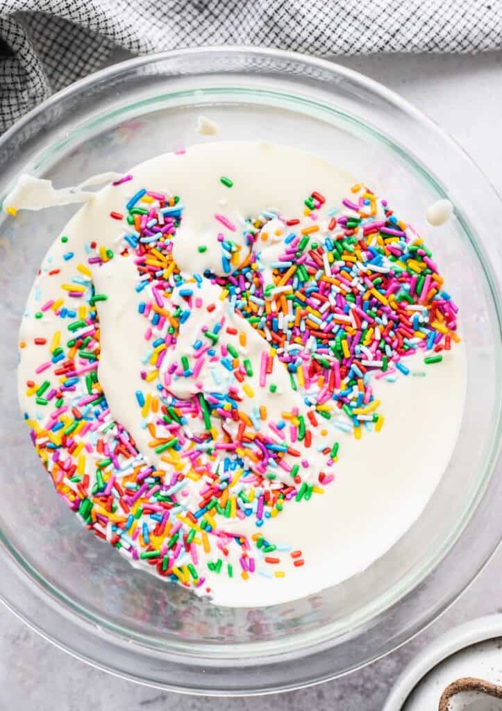 Funfetti cheesecake batter in a glass bowl.