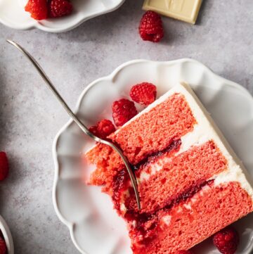 Raspberry white chocolate cake on a plate.