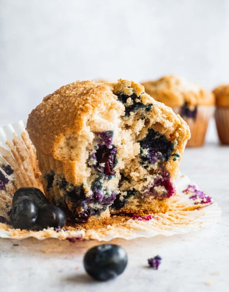 Sour cream blueberry muffins on the liner showing the inside.