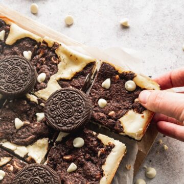 Oreo cookie dough bars with a hand pulling one away.