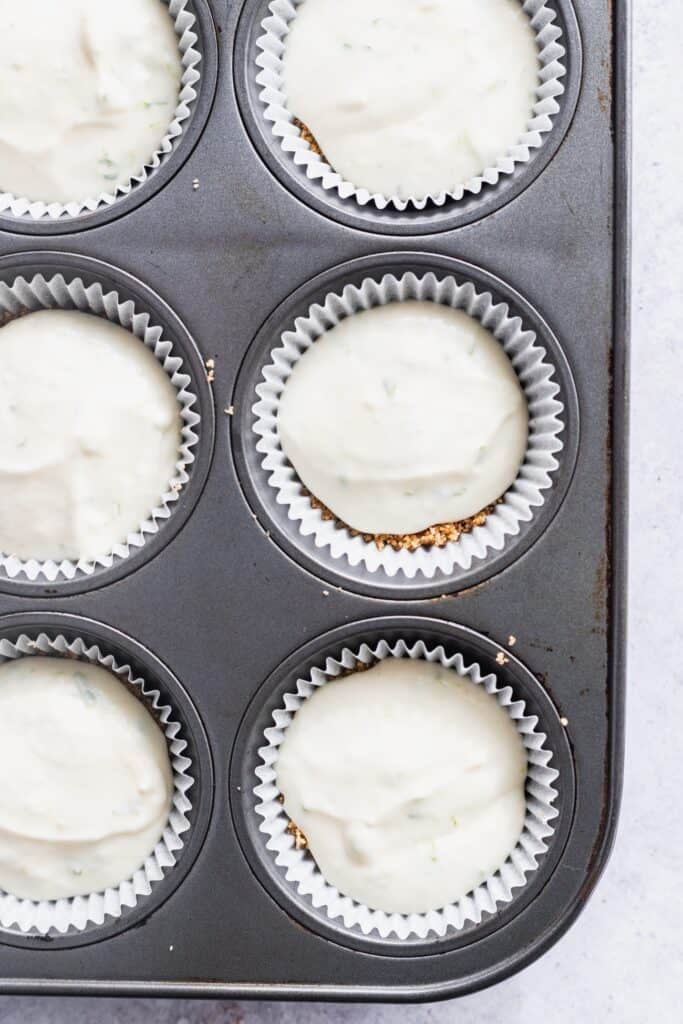 Cheesecake batter in a muffin tin.