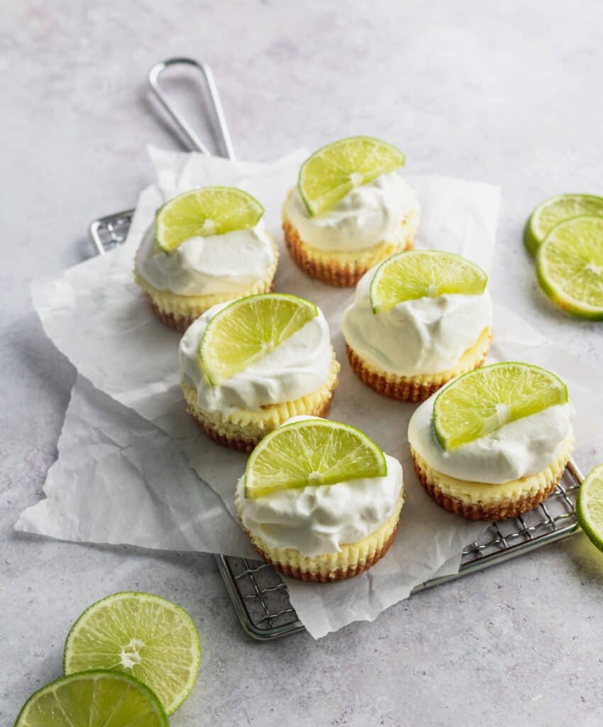 Mini key lime cheesecakes on a wire rack.