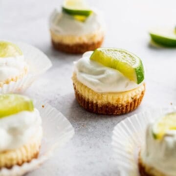 Mini key lime cheesecakes with fresh whipped cream on top.