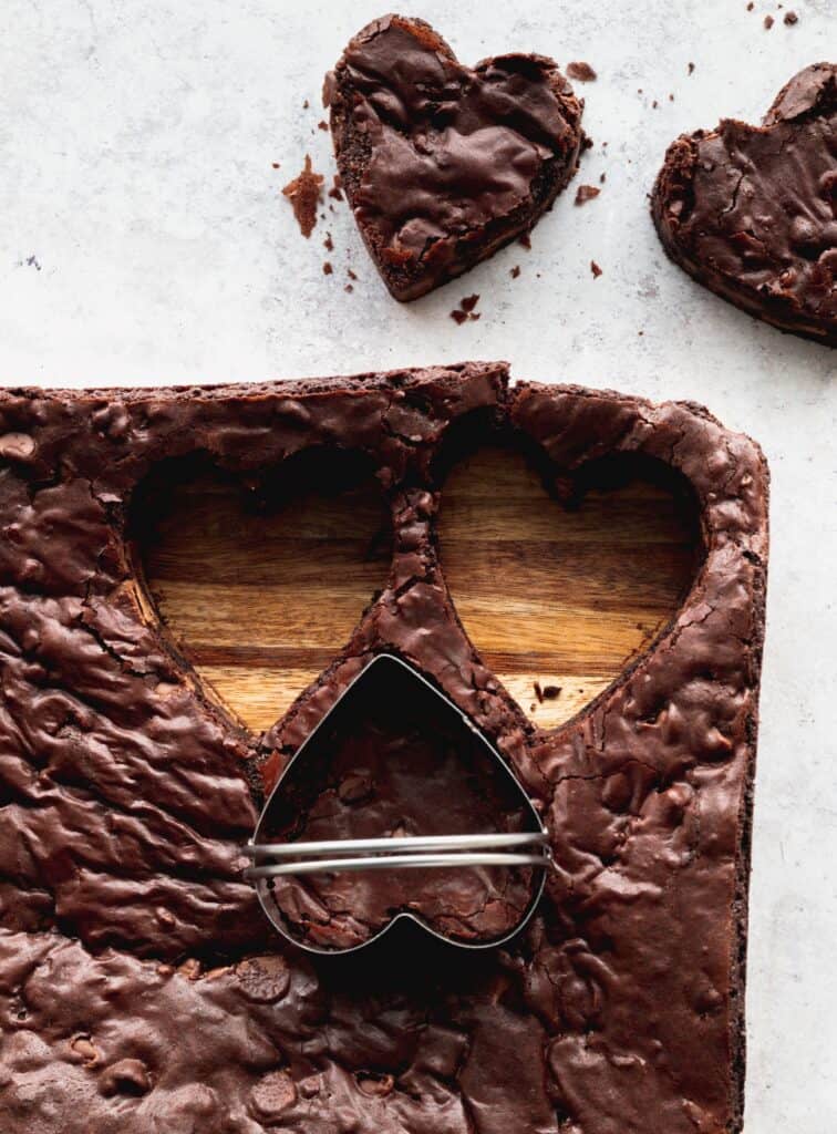 Cutting out hearts in the brownies.