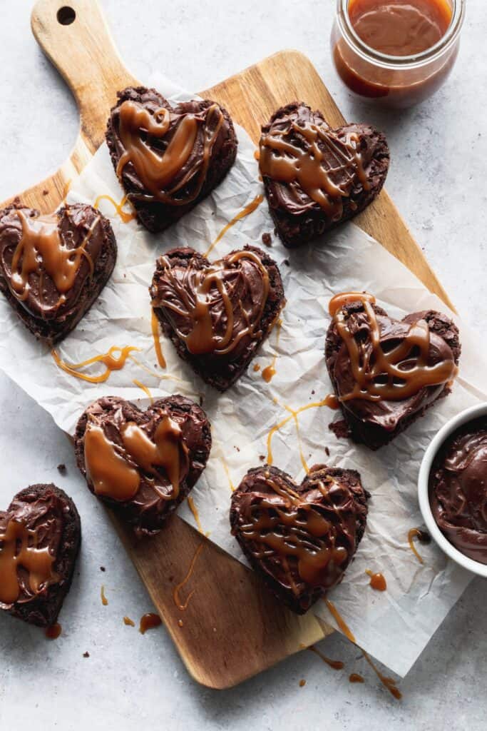 Heart shaped brownies with salted caramel on top.