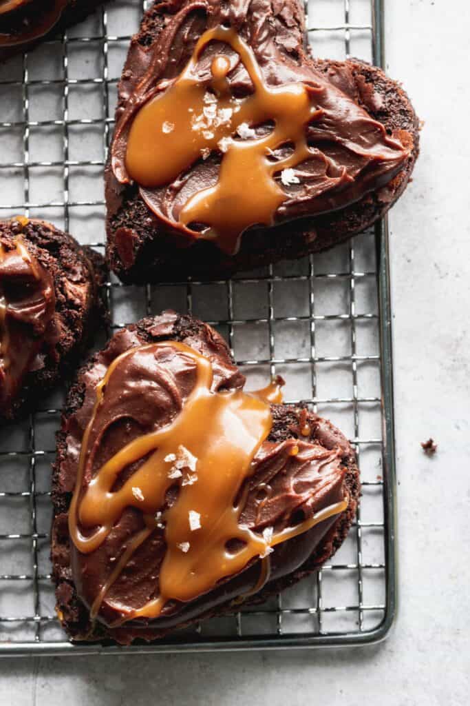 Heart shaped brownies on a wire grate.