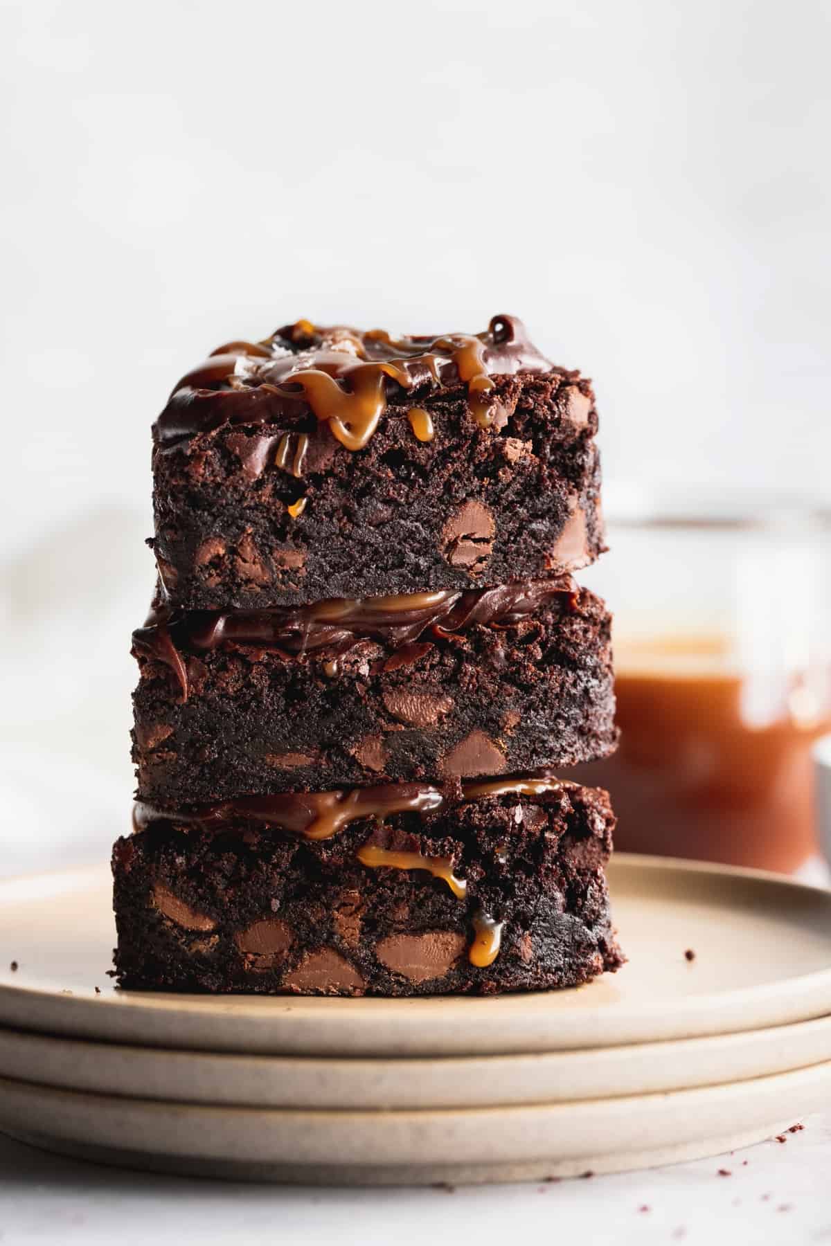 Stack of fudgy brownies on plates.