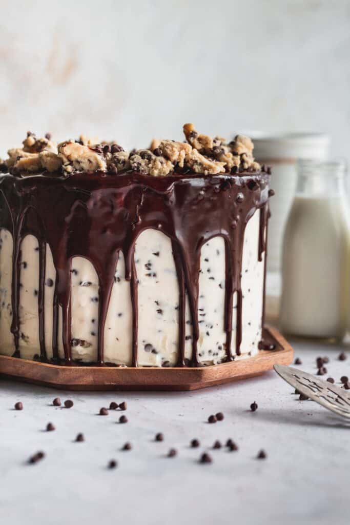 Cookie dough cake on wood plate.