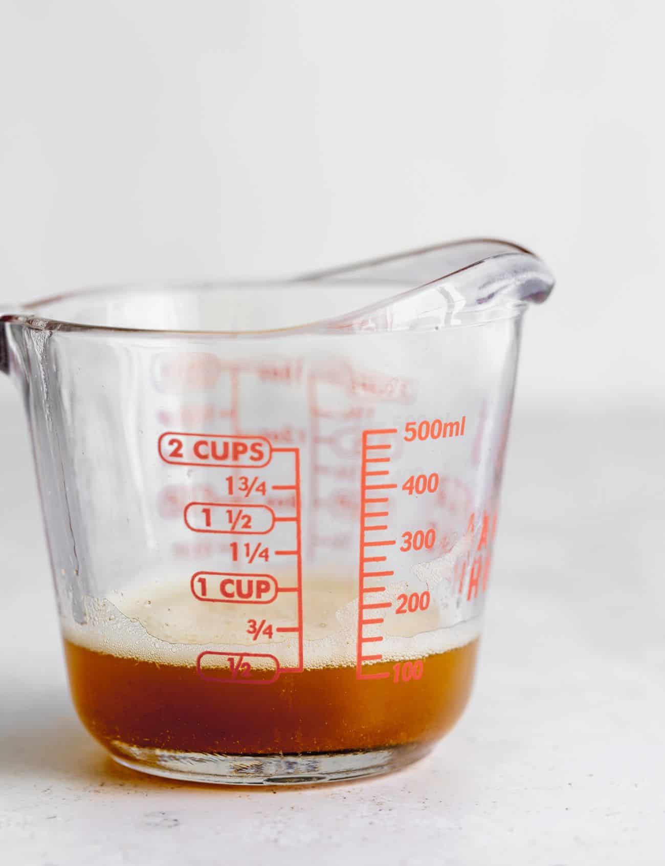 Brown butter in glass measuring cup.