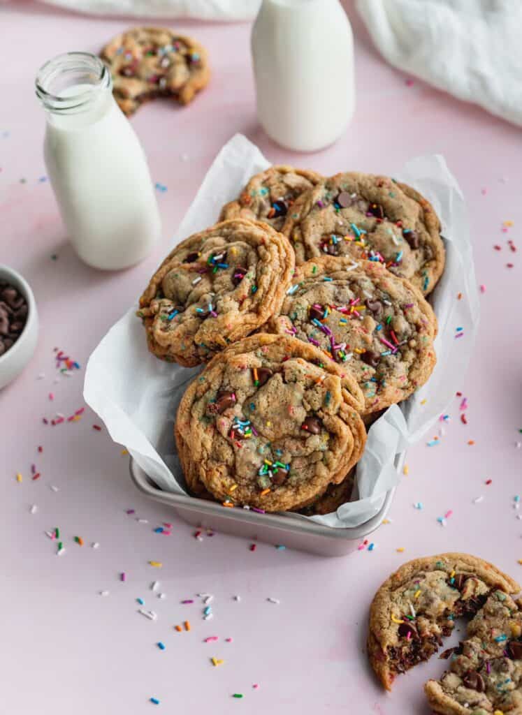 Sprinkle chocolate chip cookies in a tin.