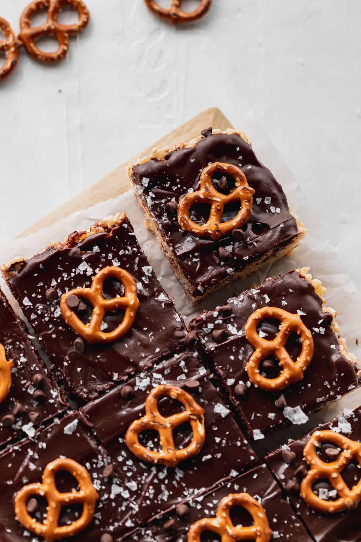 Chocolate covered Rice Krispie treats with pretzels on top.