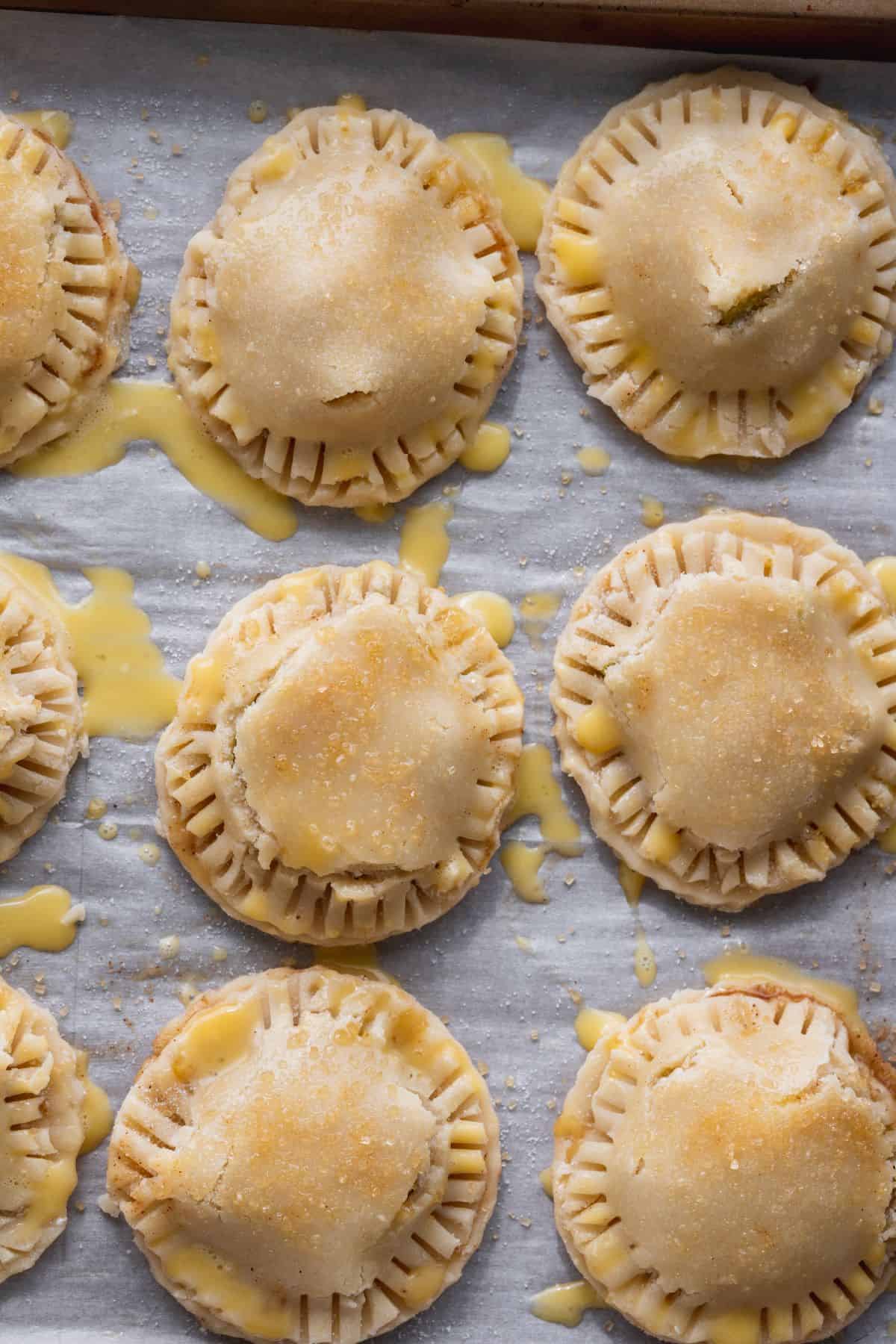 Pear pies covered in egg wash.