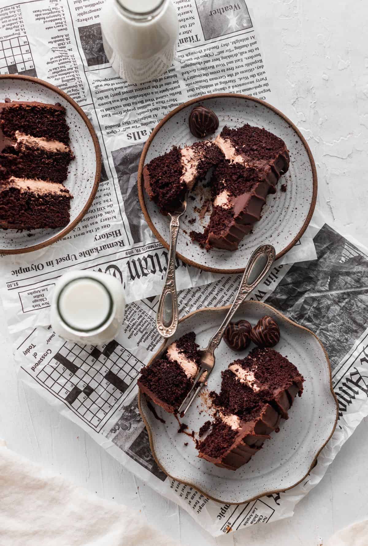 Mini chocolate cake slices on newspaper.