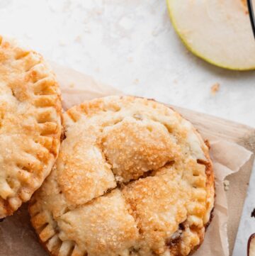 Butterscotch pear turnovers on a wood board.