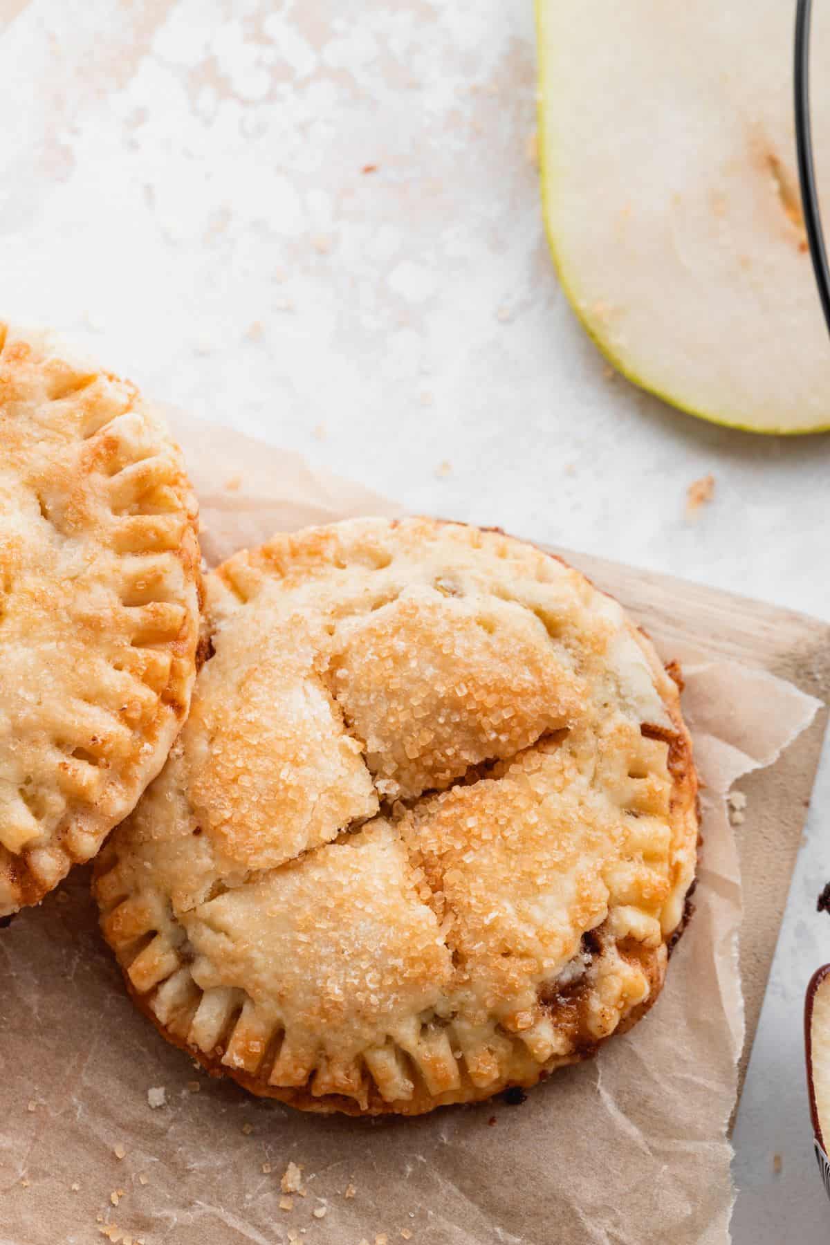 Butterscotch pear turnovers on a wood board.