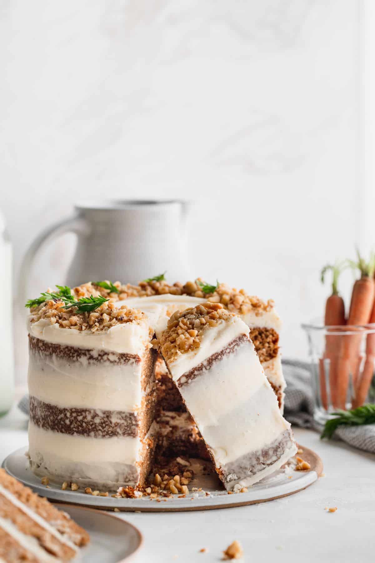 Brown butter carrot cake with a piece on its side.