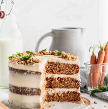Brown butter carrot cake on a wood stand.