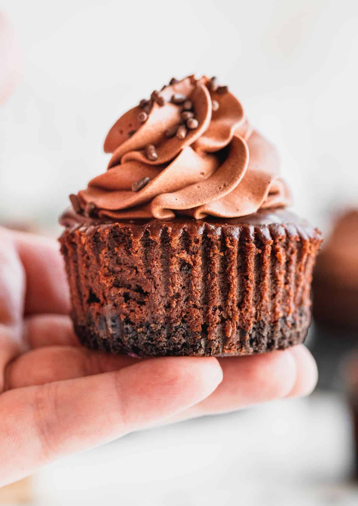 Holding a cake in hand.