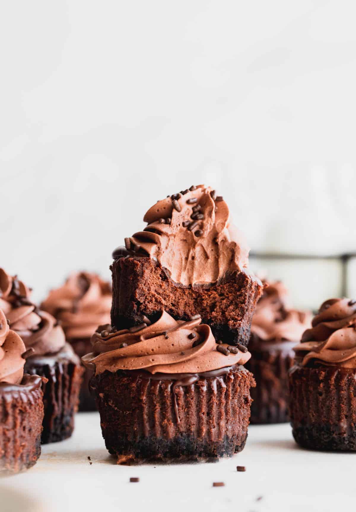 Stacked mini chocolate cheesecakes with a bite missing.