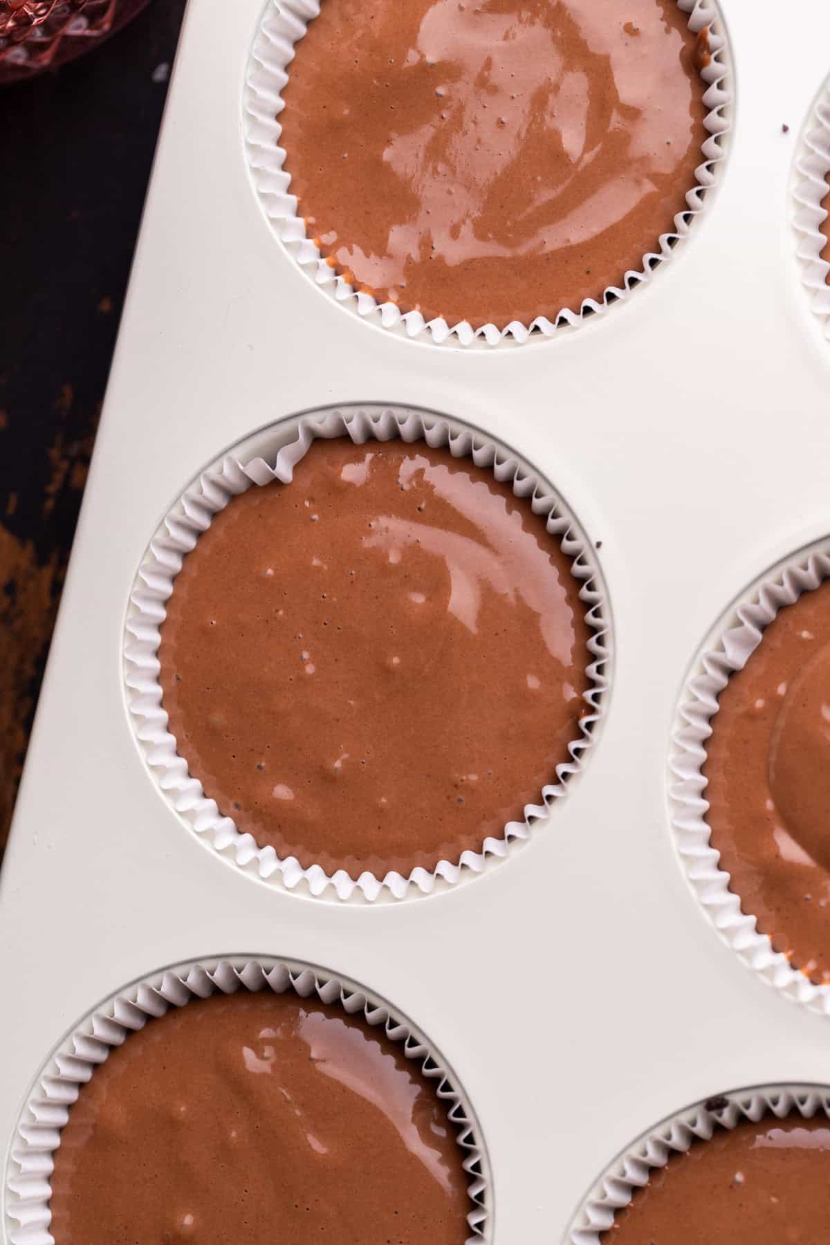 Cheesecake batter in muffin pan.